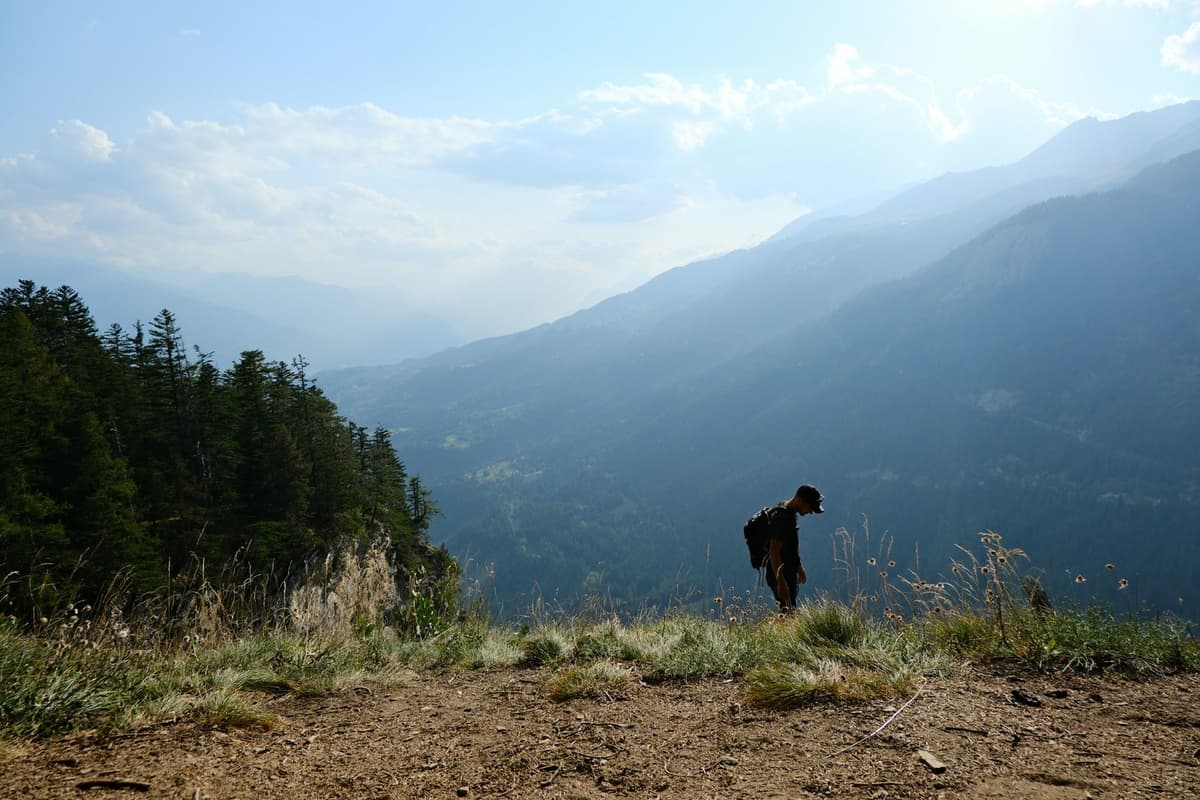 A hiker on the forested ridge trail with valley views on the Sundarijal to Chisapani hike