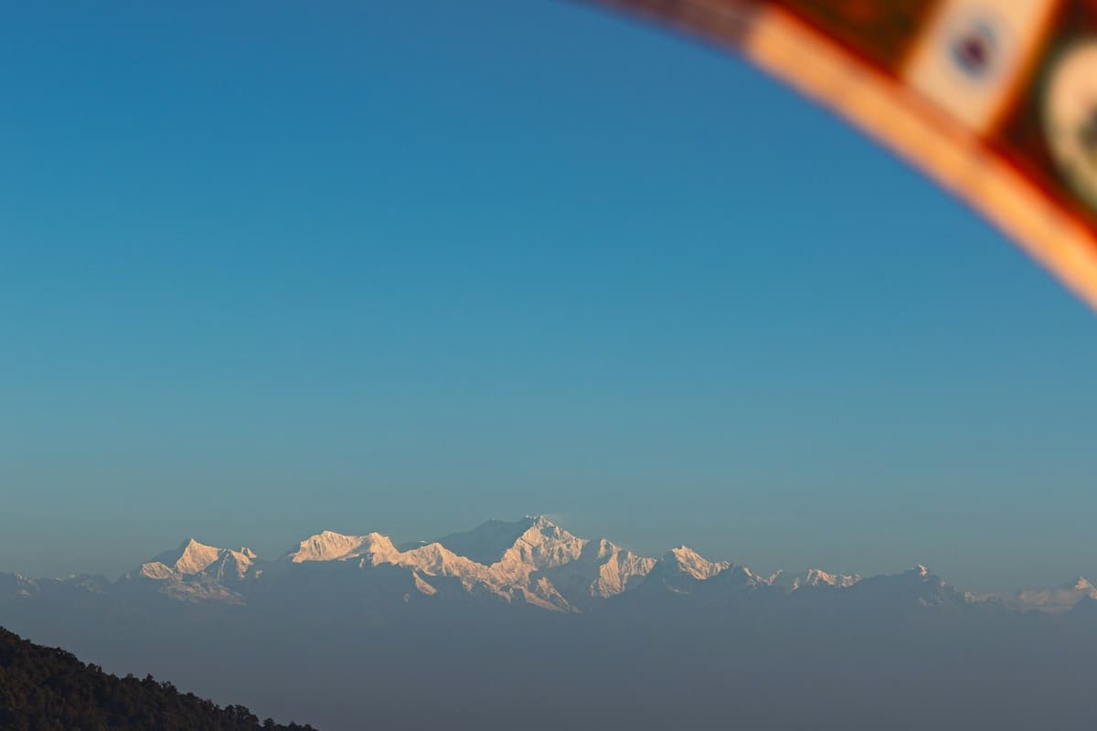 The snow-capped Himalaya seen far off from a hill viewpoint on the Kulekhani and Daman tour