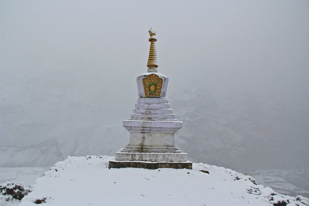 A white shrine standing in fresh snow and mist at the top of the Kalinchowk with Palanchowk Bhagwati tour