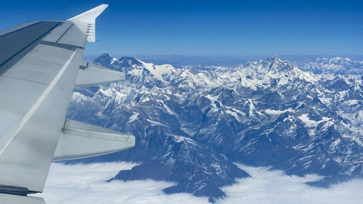 The Everest range beside the aircraft wing on the Everest mountain flight