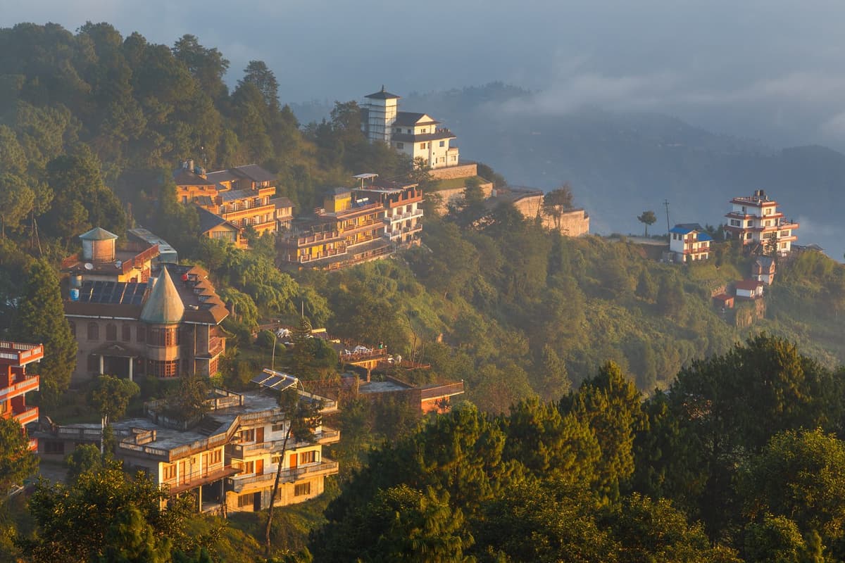 Hotels and houses on the forested Nagarkot ridge above the clouds, the destination of the Changu Narayan to Nagarkot hike.