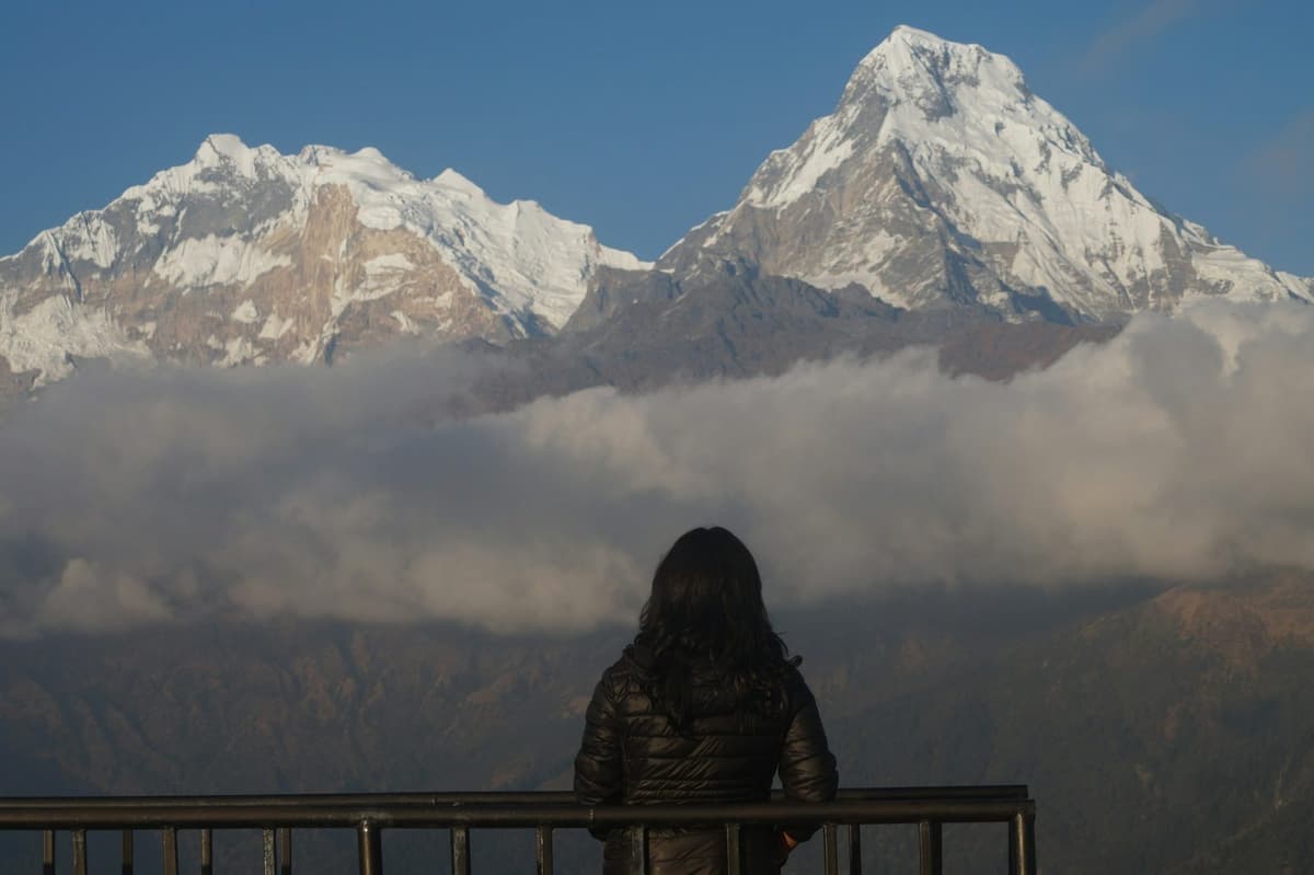 Trekker watching Annapurna South at sunrise from the viewpoint on the Poon Hill trek