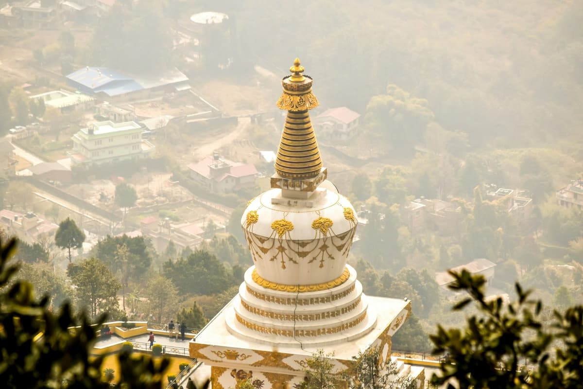 A white and gold stupa above the Kathmandu Valley in Shivapuri Nagarjun National Park, passed on the Shivapuri hike.