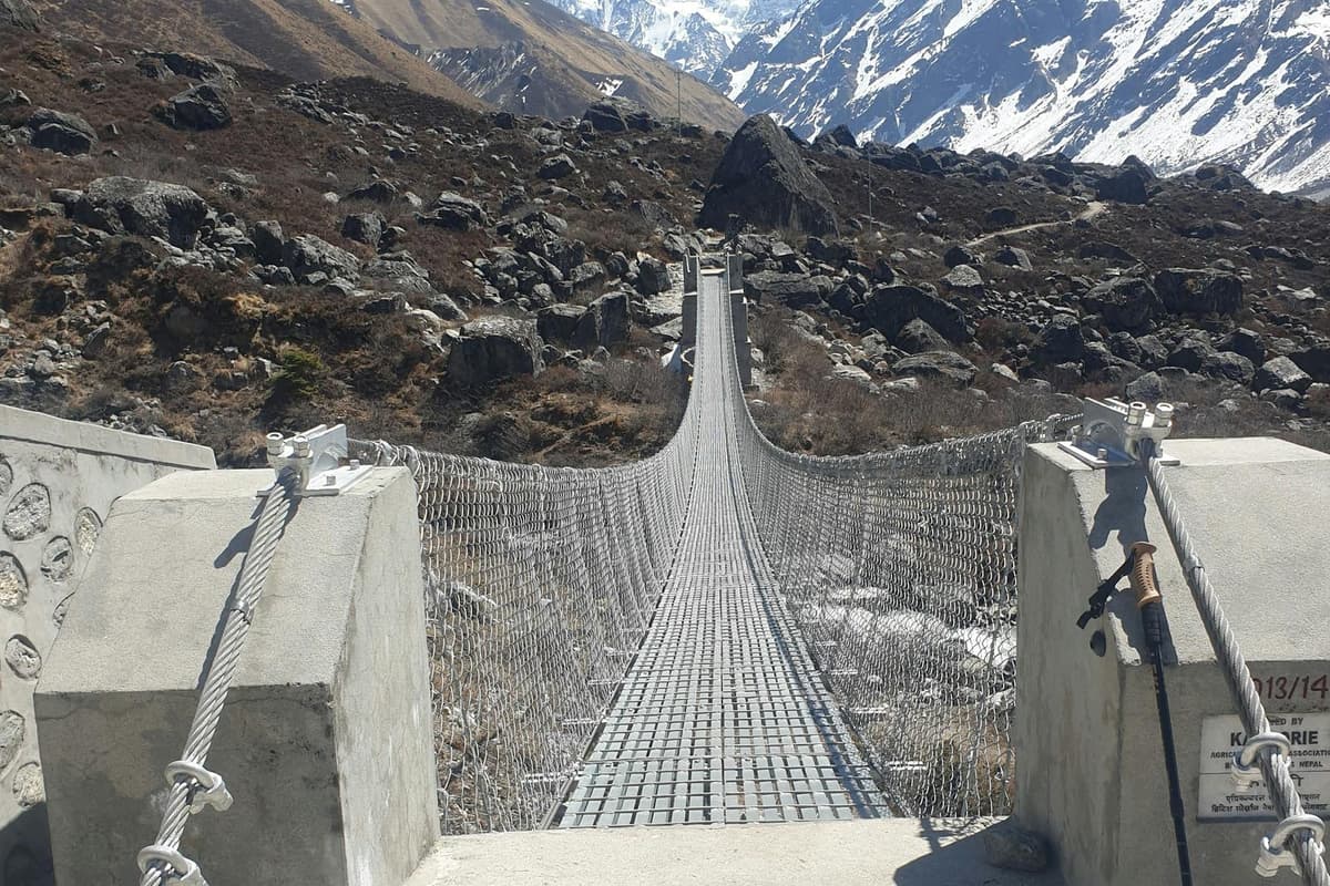 A long suspension bridge across the river gorge on the Manaslu Circuit trek from Kathmandu