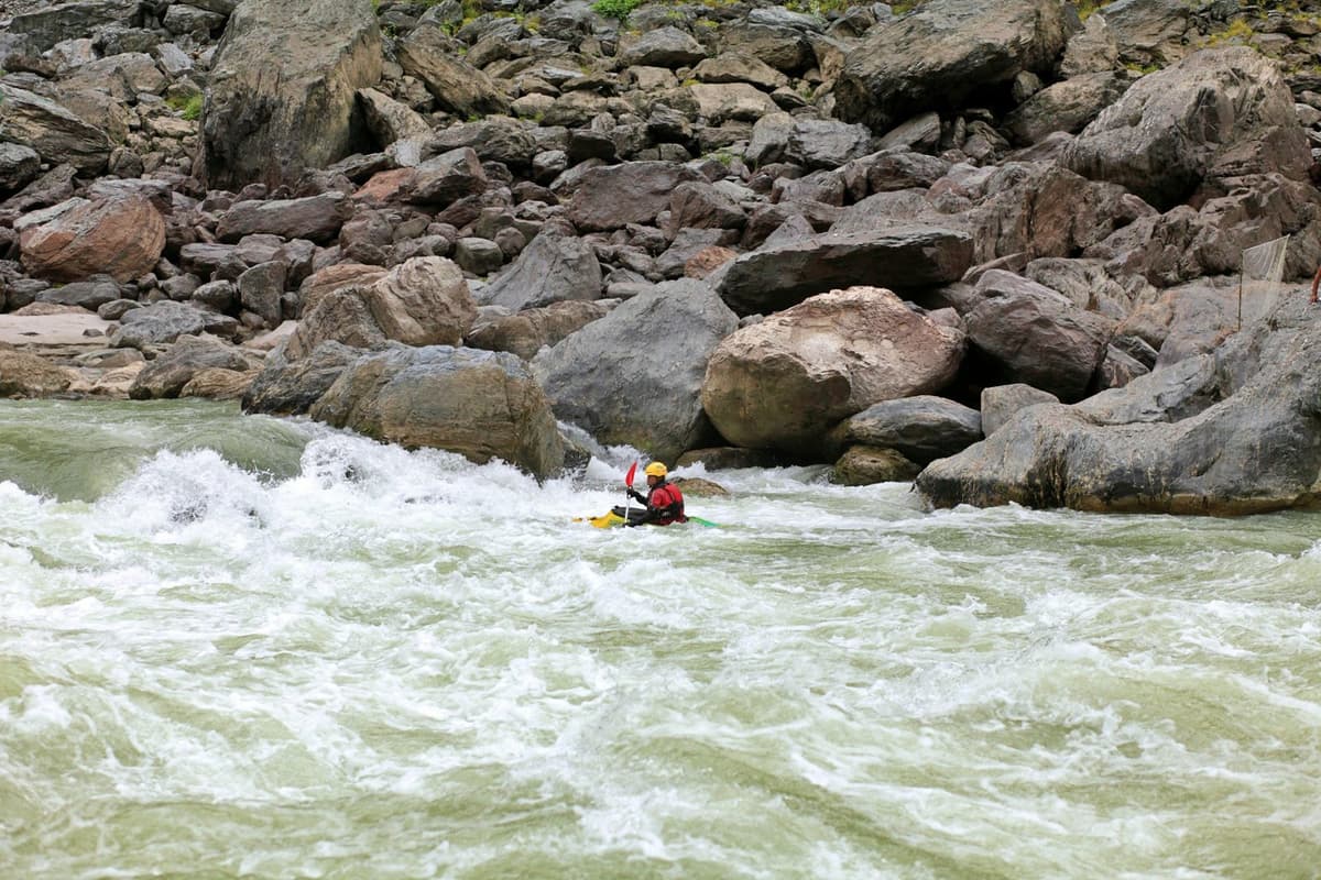 A kayaker following the rafts down the river on a Trishuli River rafting trip
