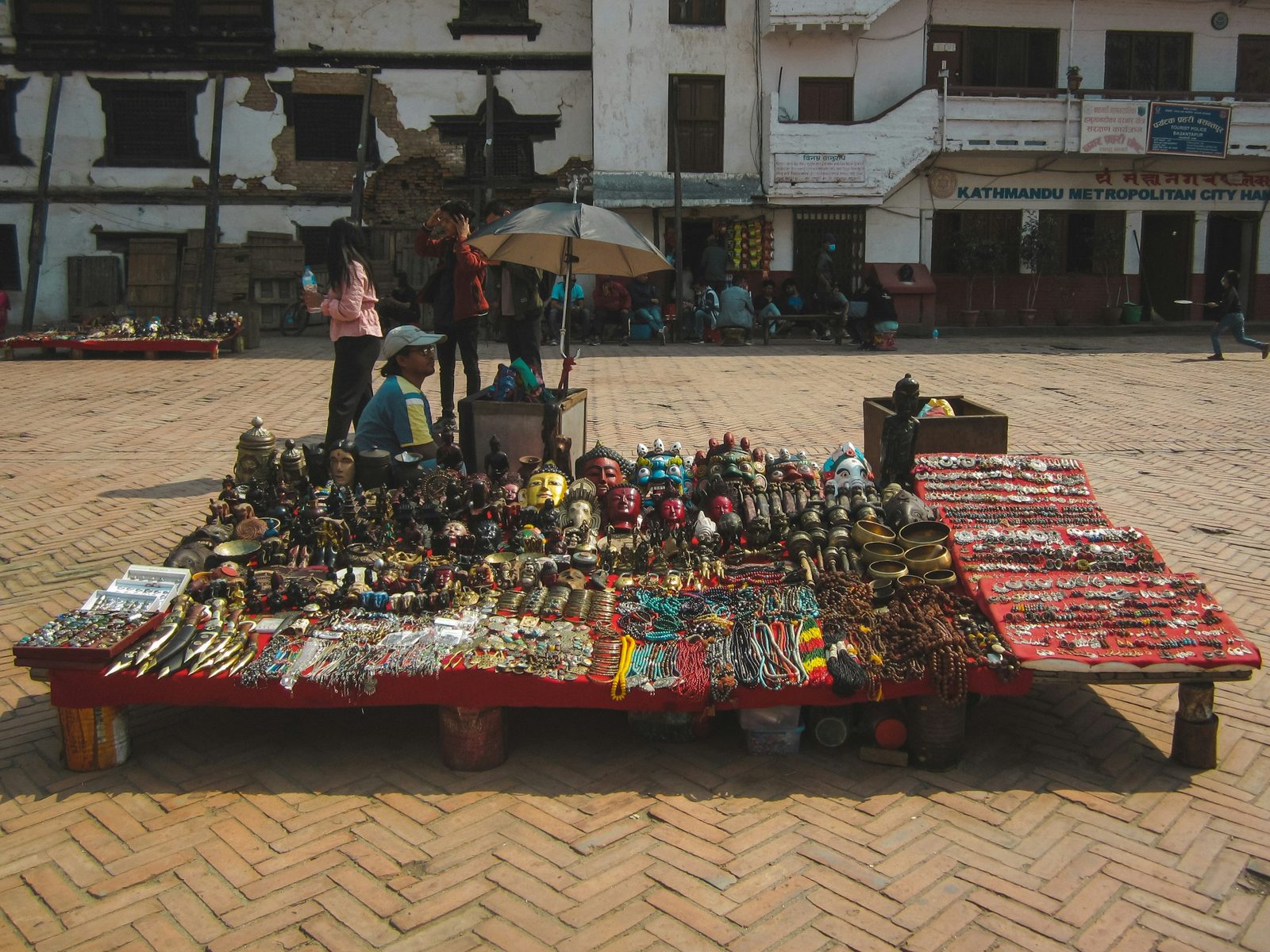 A souvenir stall of masks and metalwork on Basantapur Square in the old city, a stop on the Kathmandu walking tour.