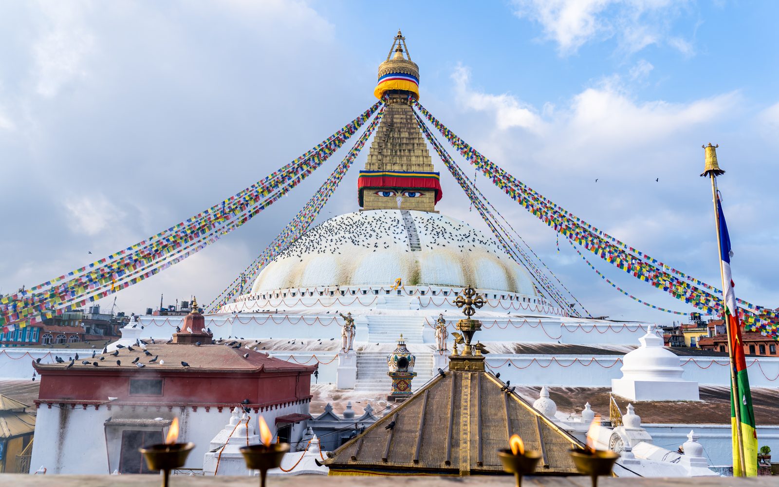 Boudhanath Stupa with prayer flags and the painted Buddha eyes, where the Boudhanath and Tarebhir hike begins.