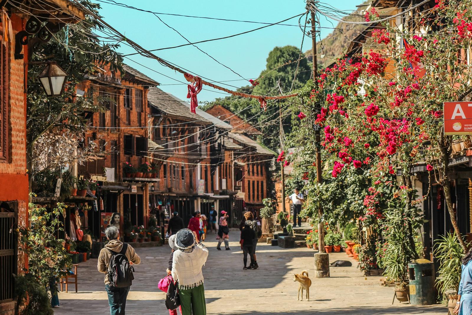 Flower-lined Newari bazaar street in Bandipur, first stop on the Bandipur Pokhara Kathmandu tour
