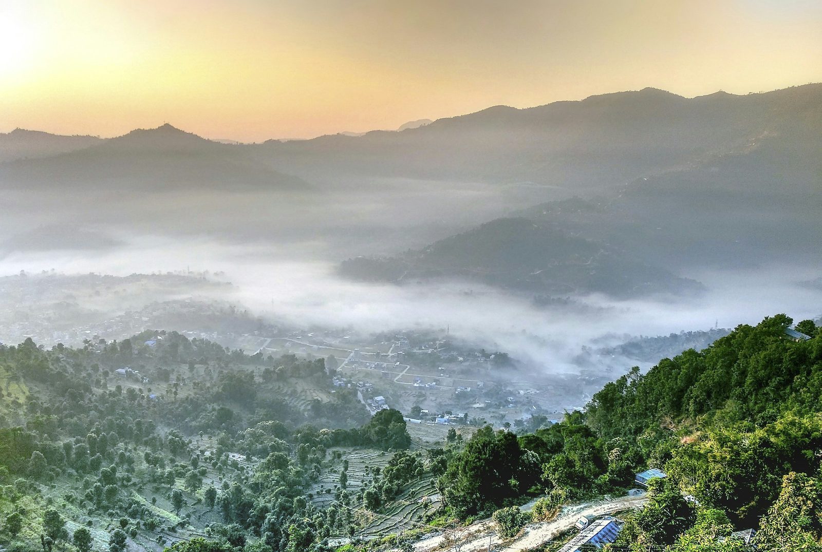 Mist filling the valleys below forested hills at dawn on the Dolakha, Charikot and Sailung tour