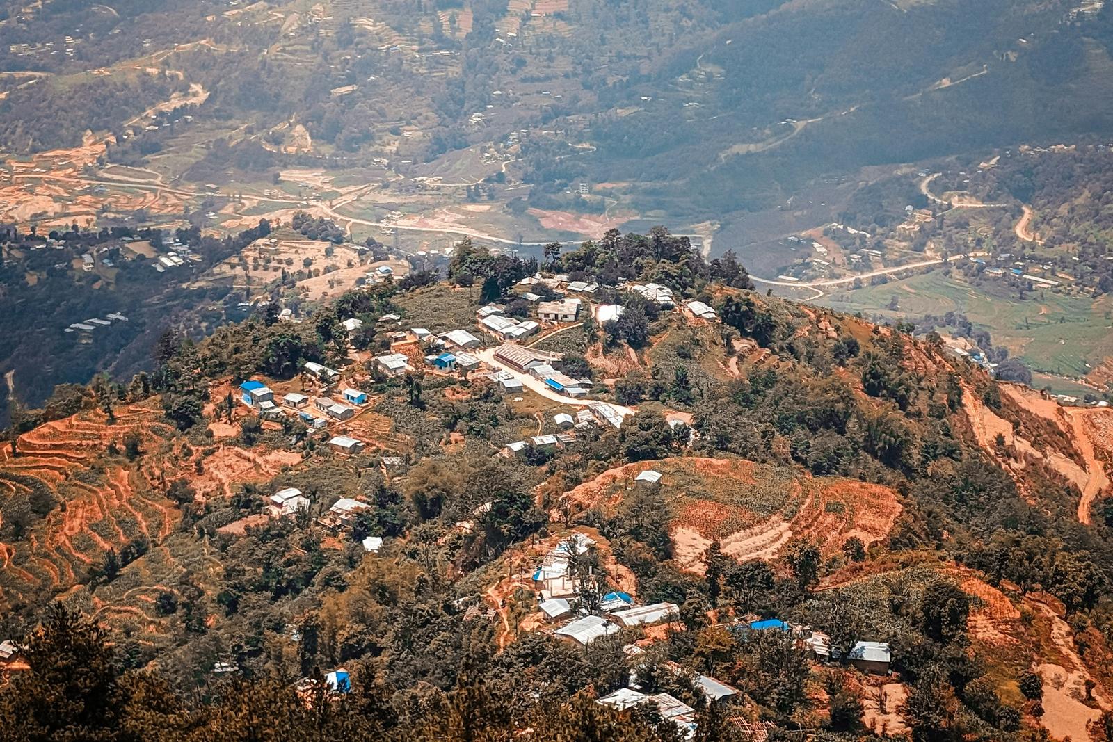 Houses and terraced fields on a Nepali hillside, the village setting of the Chitlang and Kulekhani tour