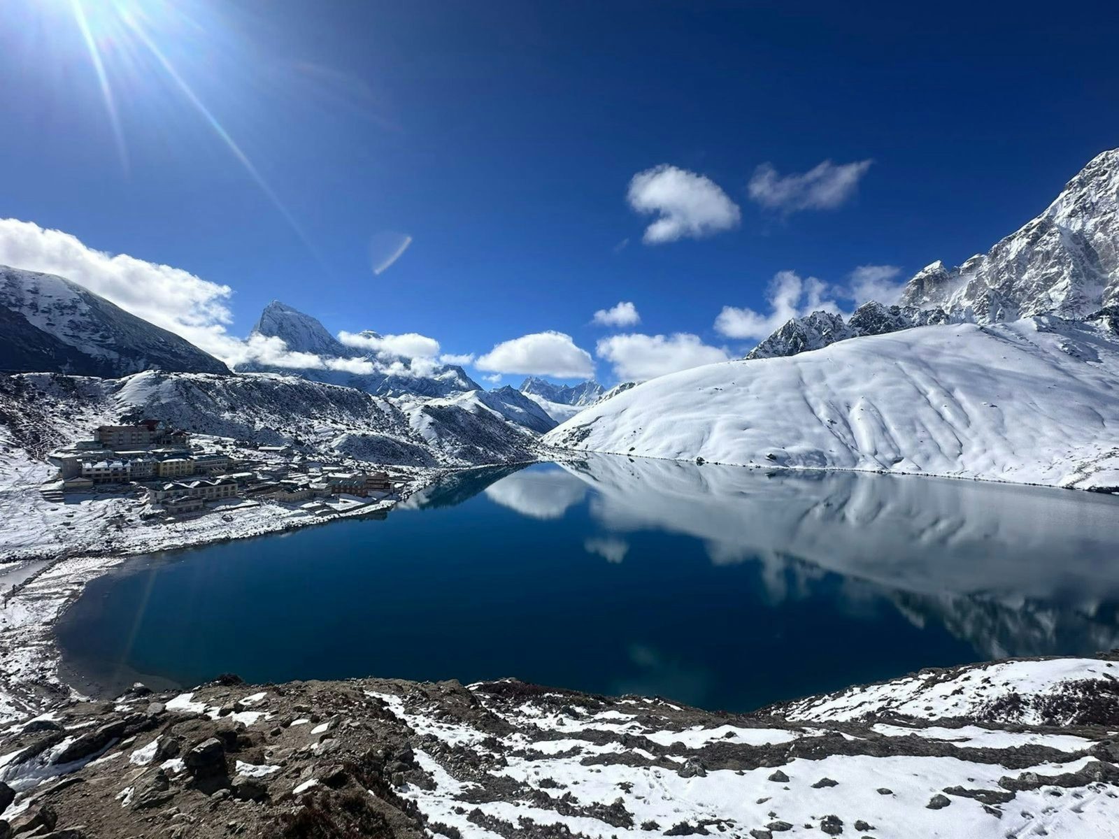 A turquoise Gokyo lake below the peaks on the Everest Three Passes trek with Gokyo Lakes