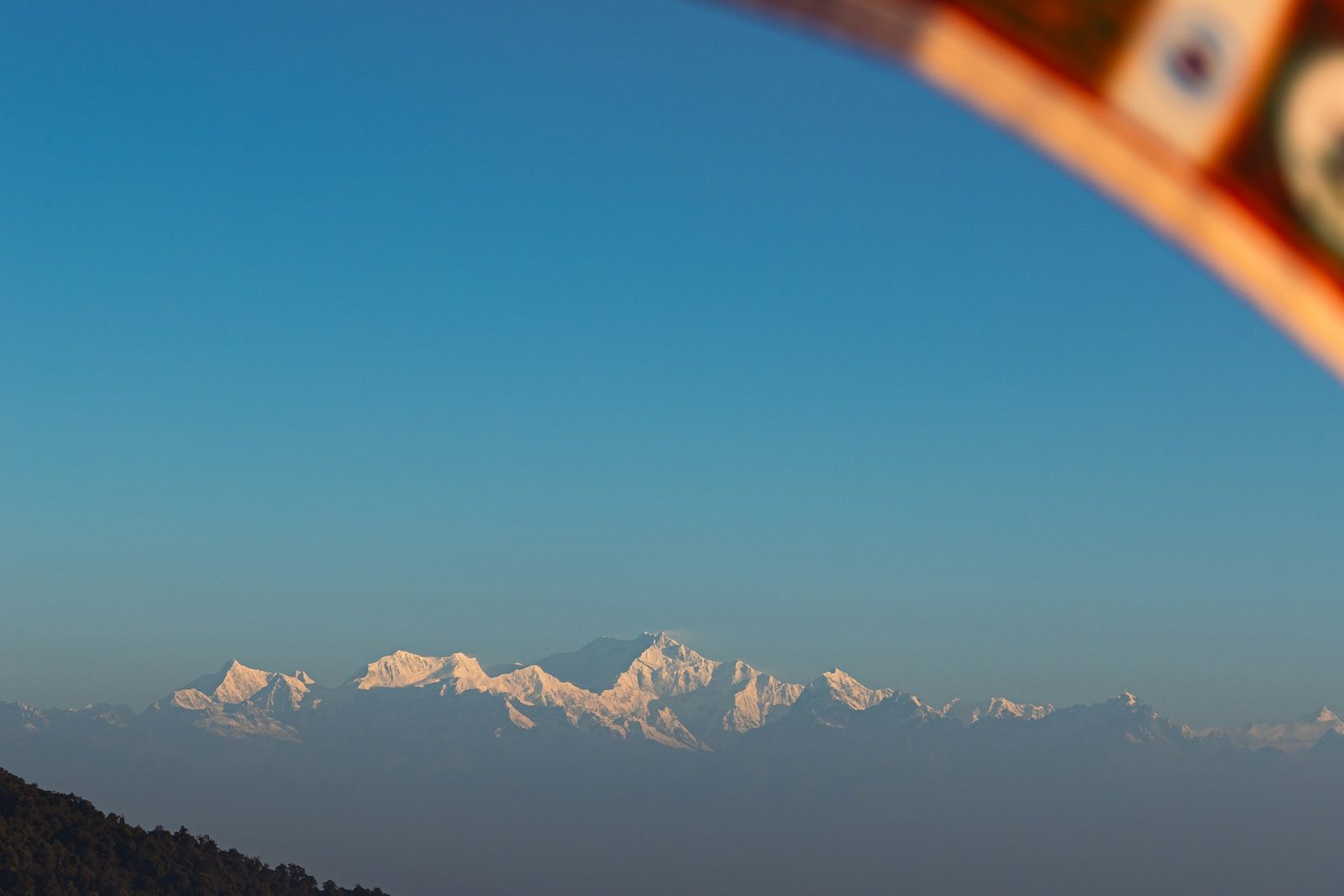 The snow-capped Himalaya seen far off from a hill viewpoint on the Kulekhani and Daman tour