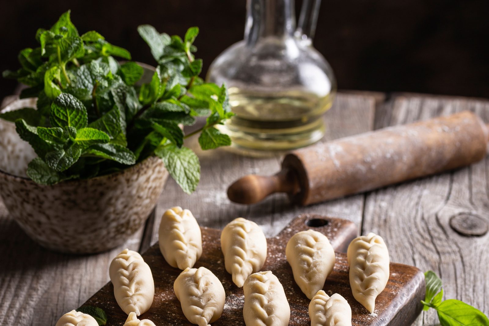 Freshly shaped momo on a wooden board, ready for steaming during the momo making class.