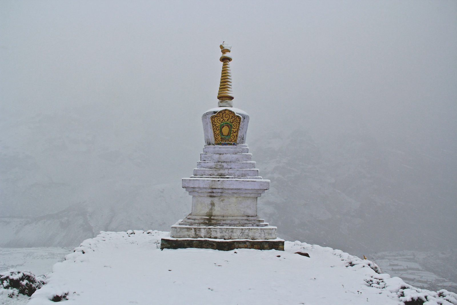 A white shrine standing in fresh snow and mist at the top of the Kalinchowk with Palanchowk Bhagwati tour