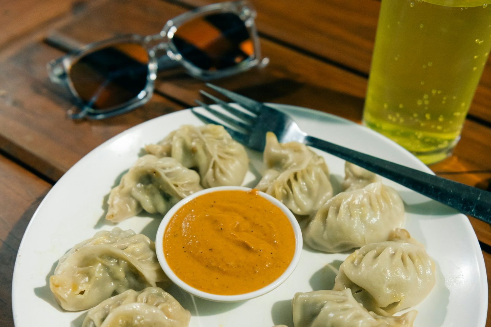 A plate of steamed Nepali momo with tomato achar, what you cook on this momo making class in Kathmandu.