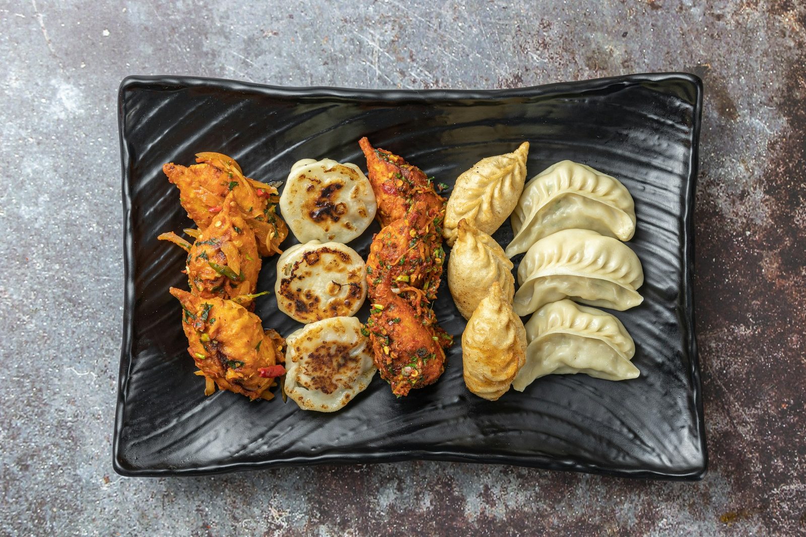 A platter of steamed and fried momo, one of the dishes you cook on the Nepali cooking class in Kathmandu.