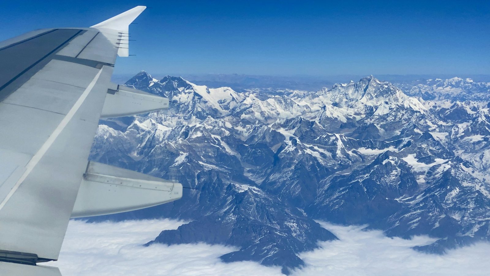 The Everest range beside the aircraft wing on the Everest mountain flight