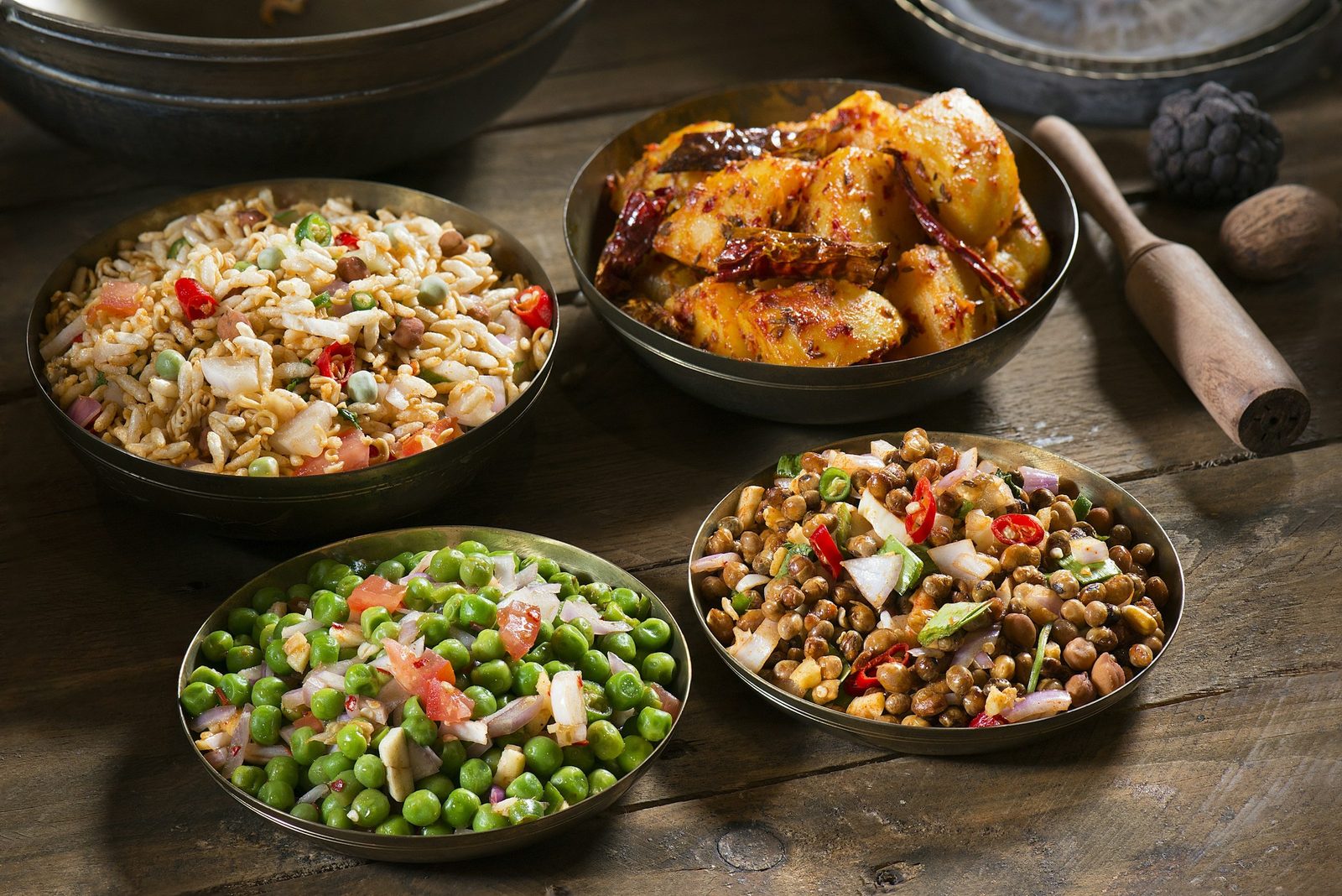 A table of Nepali dishes in Kathmandu, from beaten rice sides to spiced chicken, cooked on the Nepali cooking class.