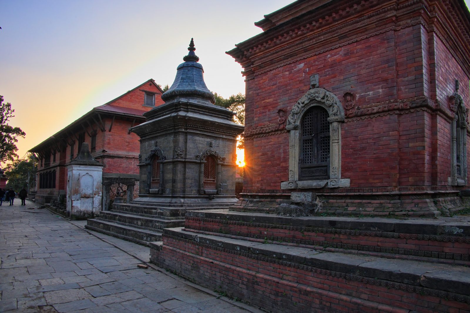 Stone shrines and brick temples beside the Bagmati River at Pashupatinath in Kathmandu, seen on the Patan, Boudhanath and Pashupatinath tour.