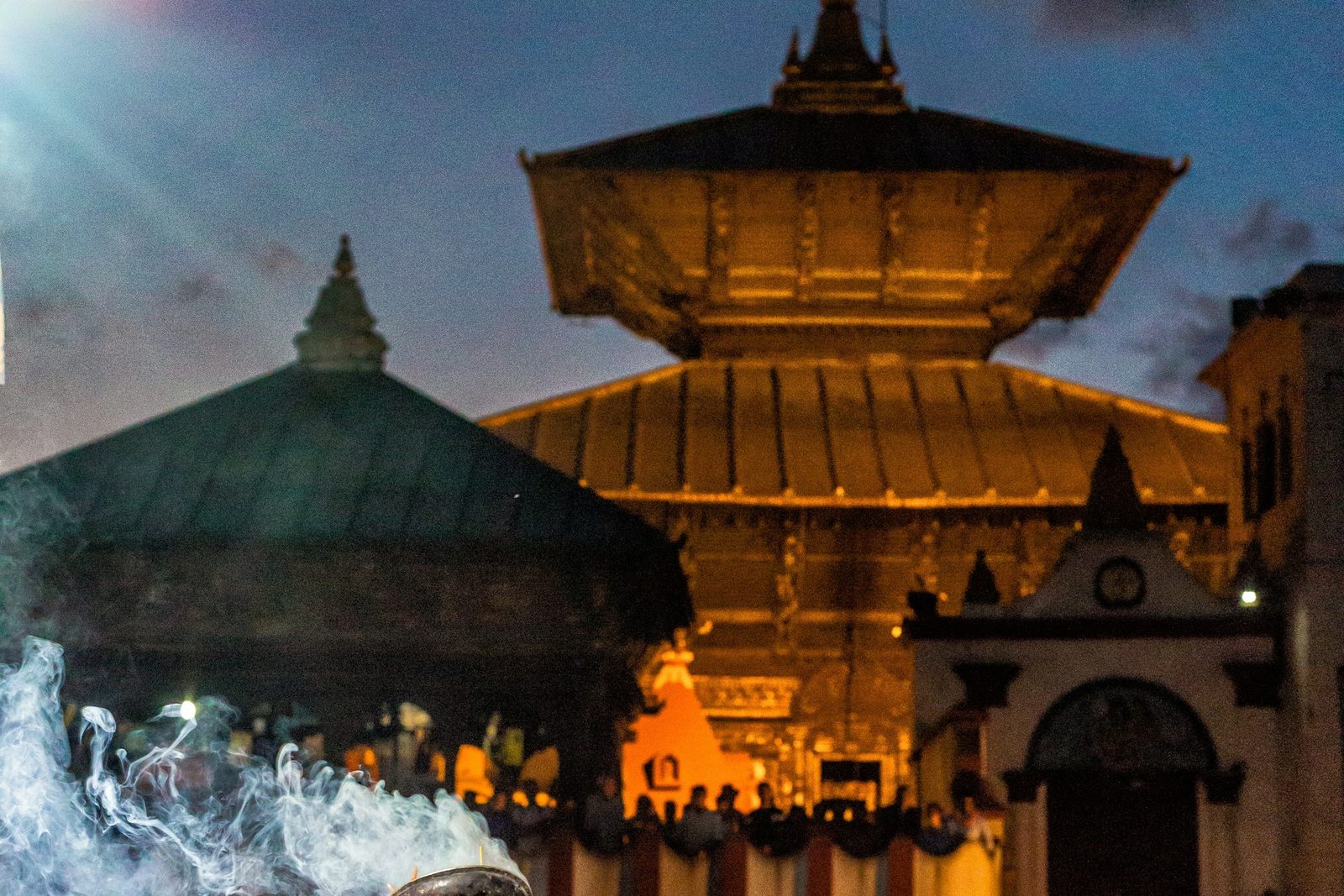 Pashupatinath Temple lit at night with incense smoke, the setting for the evening Pashupatinath aarti.