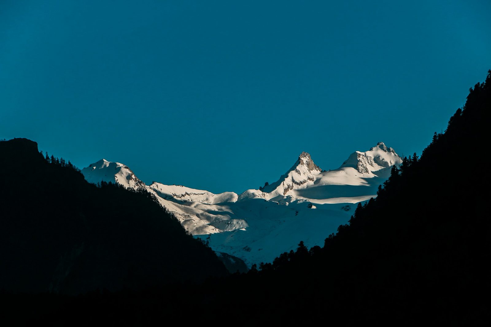 The turquoise river running through a deep gorge below a snow peak on the Manaslu Circuit trek from Kathmandu