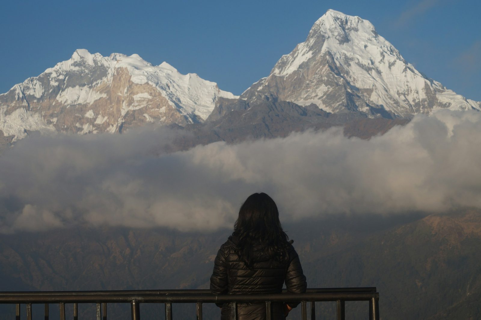 Trekker watching Annapurna South at sunrise from the viewpoint on the Poon Hill trek