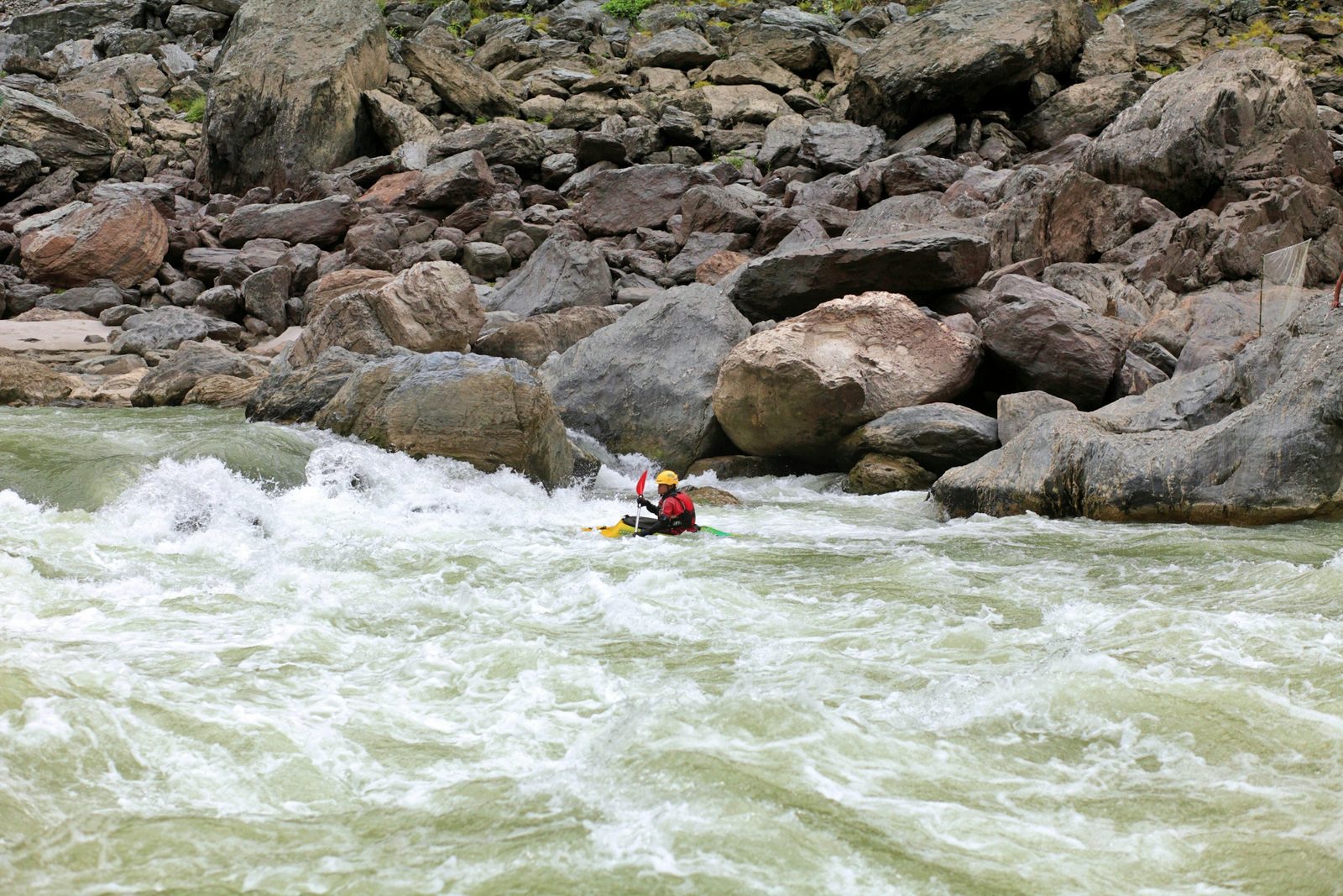 A kayaker following the rafts down the river on a Trishuli River rafting trip